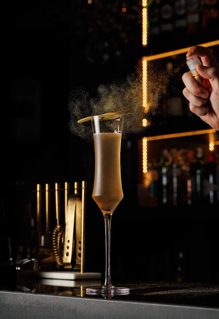 Champagne cocktail being poured at the Onyx bar
