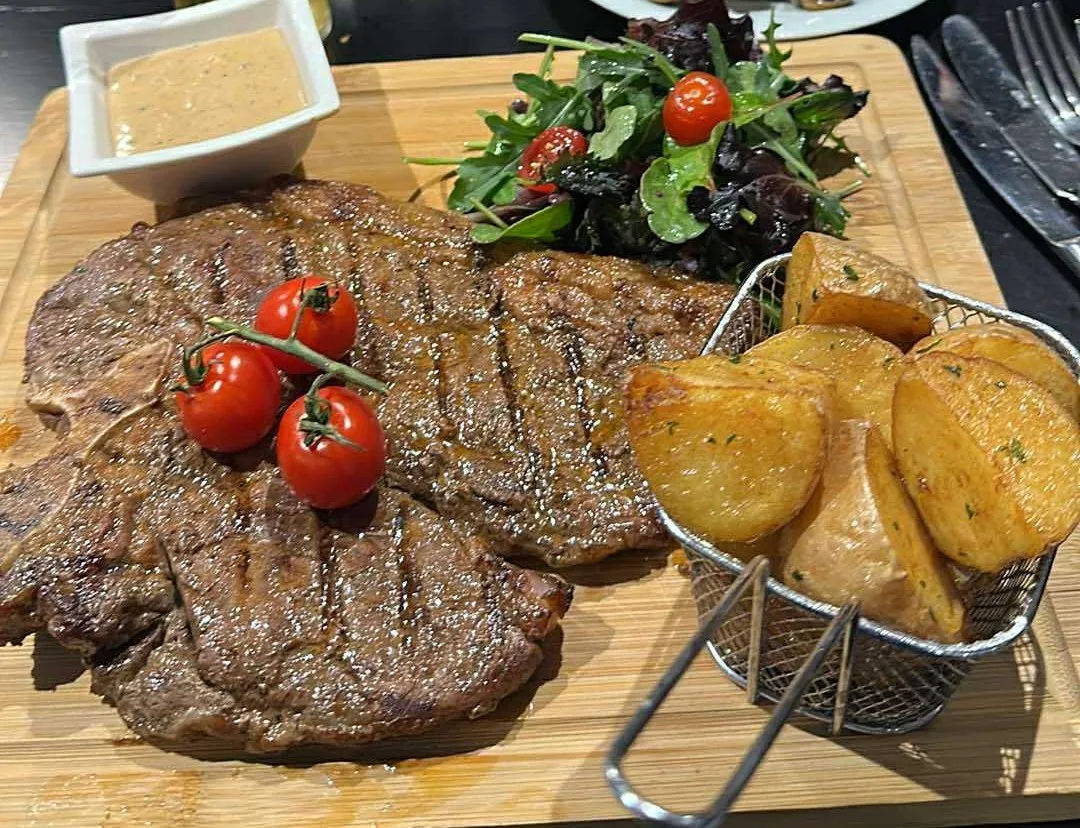 Ribeye steak served on a board at Onyx
